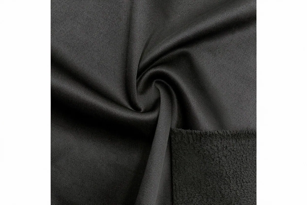 Brushed-back fleece knit fabric in charcoal cotton with soft napped surface, manufactured at Apex Corporation knitwear factory in Karachi Pakistan